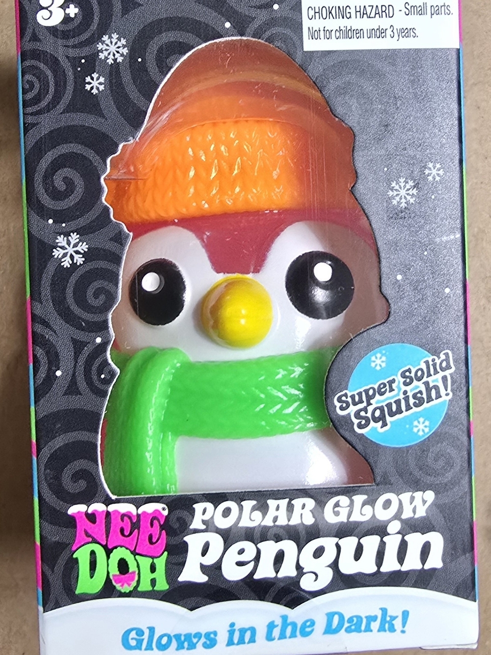 Nee Doh Polar Glow Penguin Squishy Toy - Orange Hat, Green Scarf